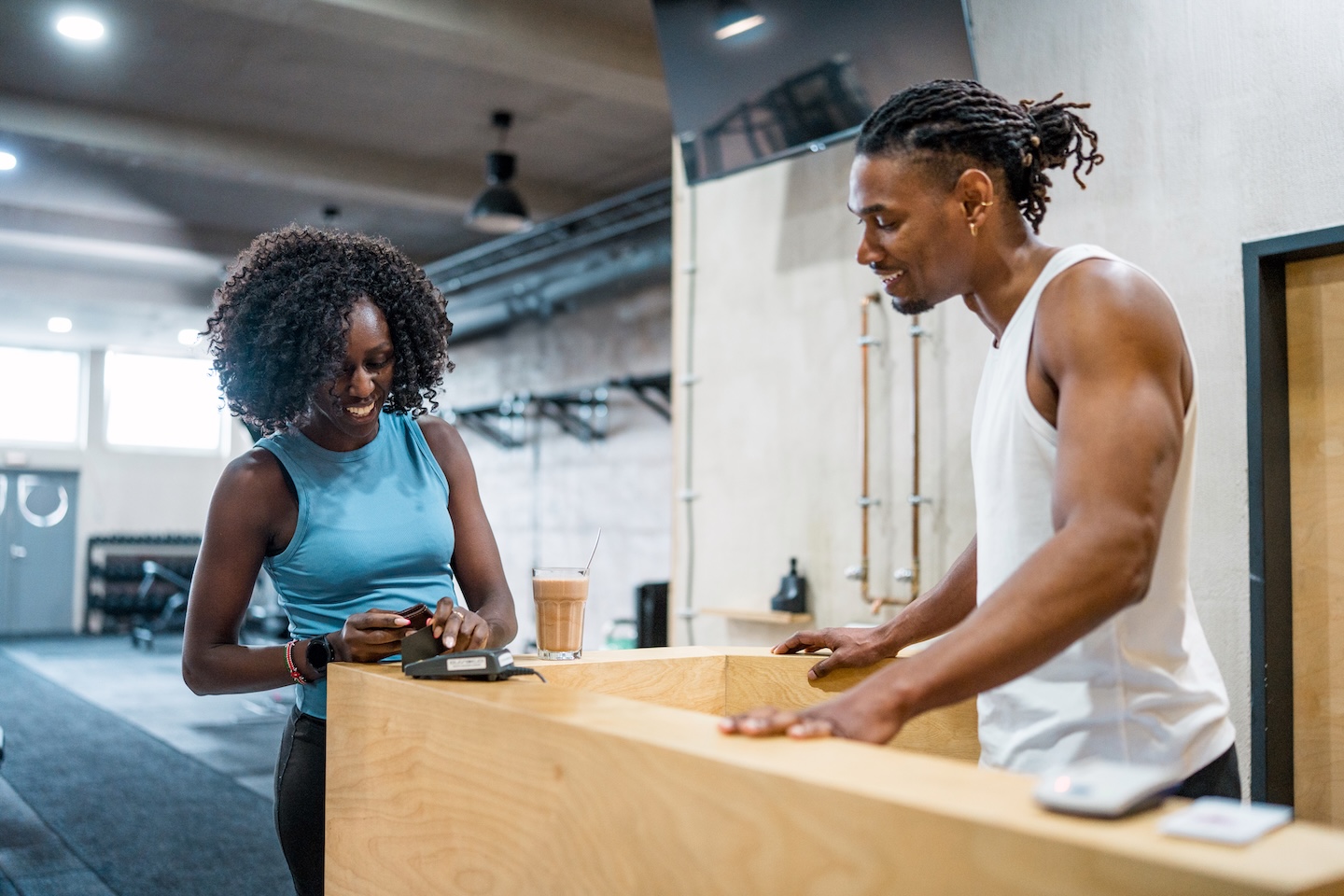 Customer and Employee at front desk of Fitness Facility