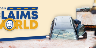 Wayne’s Claims World logo, photo of a car submerged in storm water with a tow truck about to pull it out.