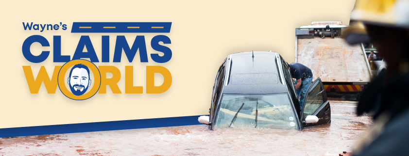 Wayne’s Claims World logo, photo of a car submerged in storm water with a tow truck about to pull it out.
