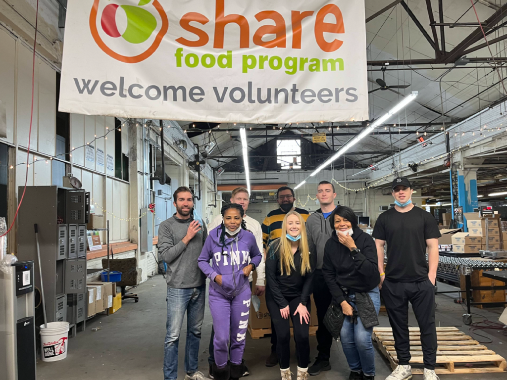 Photo of several people volunteering at a food bank