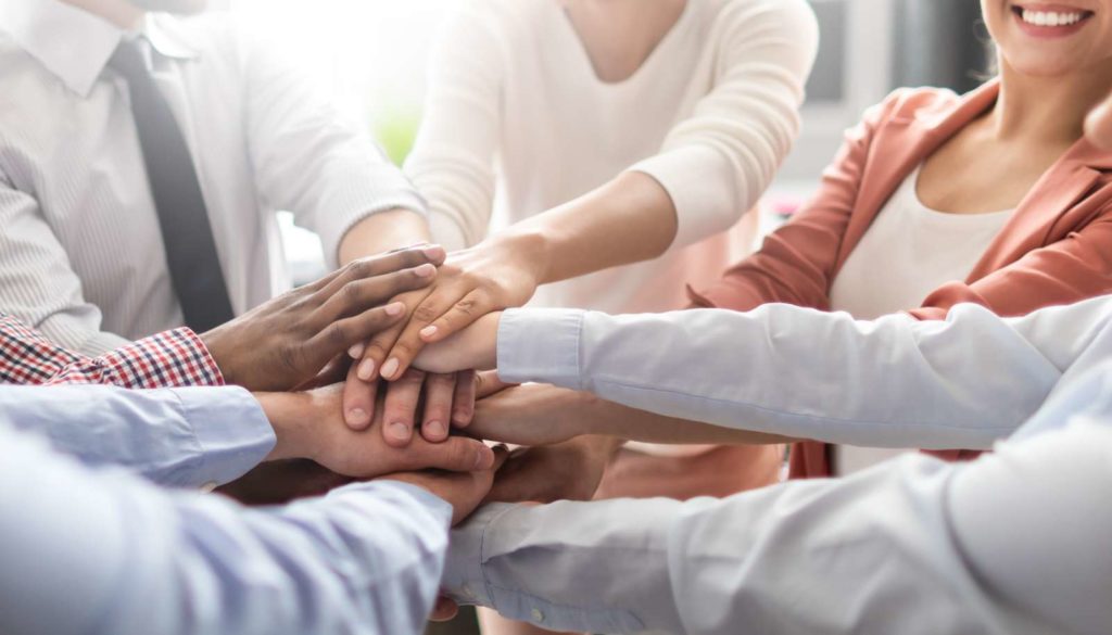 NSM-CPS-insights-how-to-become-a-better-risk-management-partner-914x258@2x group of people holding hands