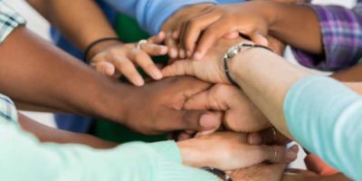group of people grabbing hands