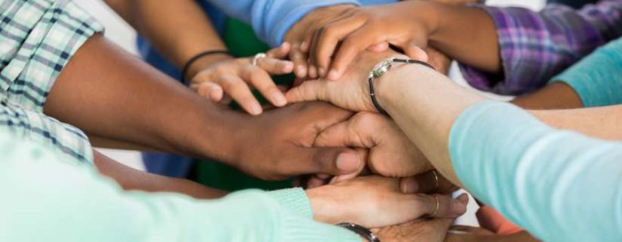 group of people grabbing hands