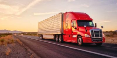 image of a tractor trailer writing down the highway