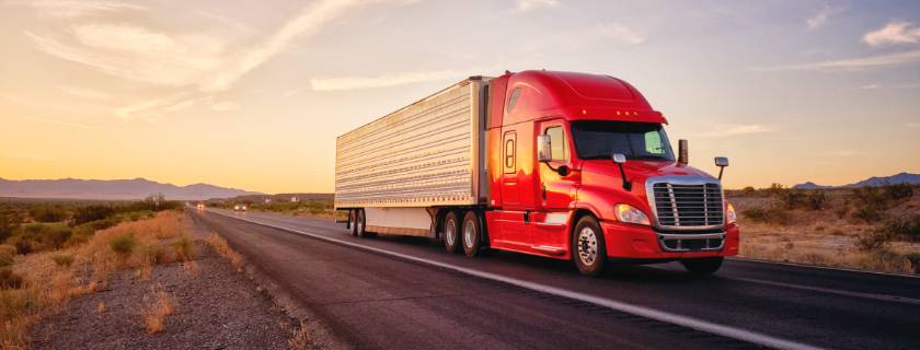 image of a tractor trailer writing down the highway