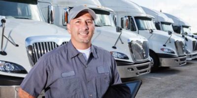man in front of tractor trailers