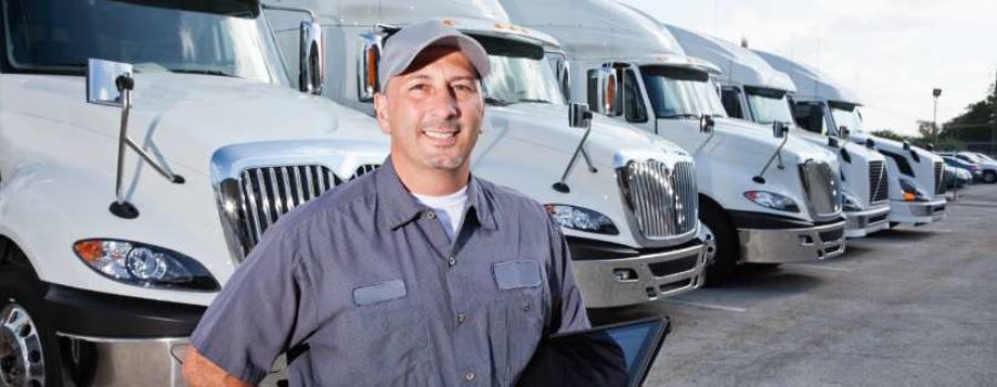 NSM-TTI-resources-understanding-owner-operator-model-420x160@2x man in front of tractor trailers