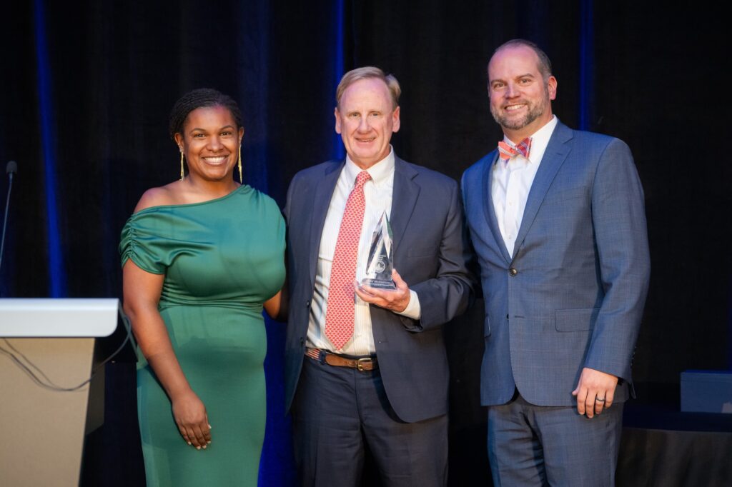 Photo Geof McKernan posing for his award with ISOP leadership