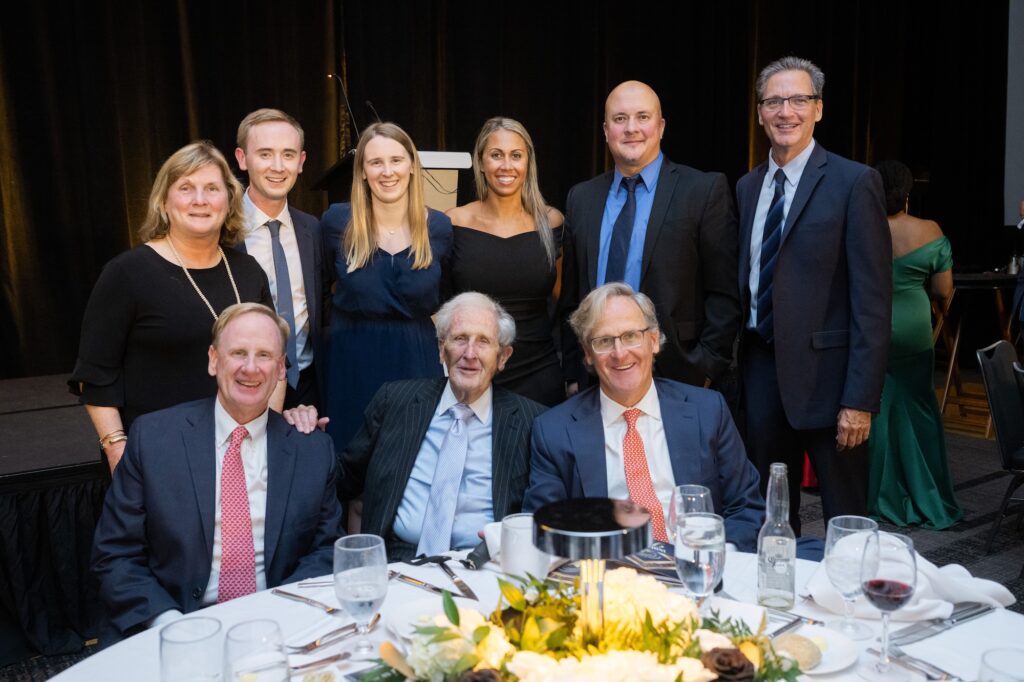 Photo of Geof McKernan posing with his family and NSM team members