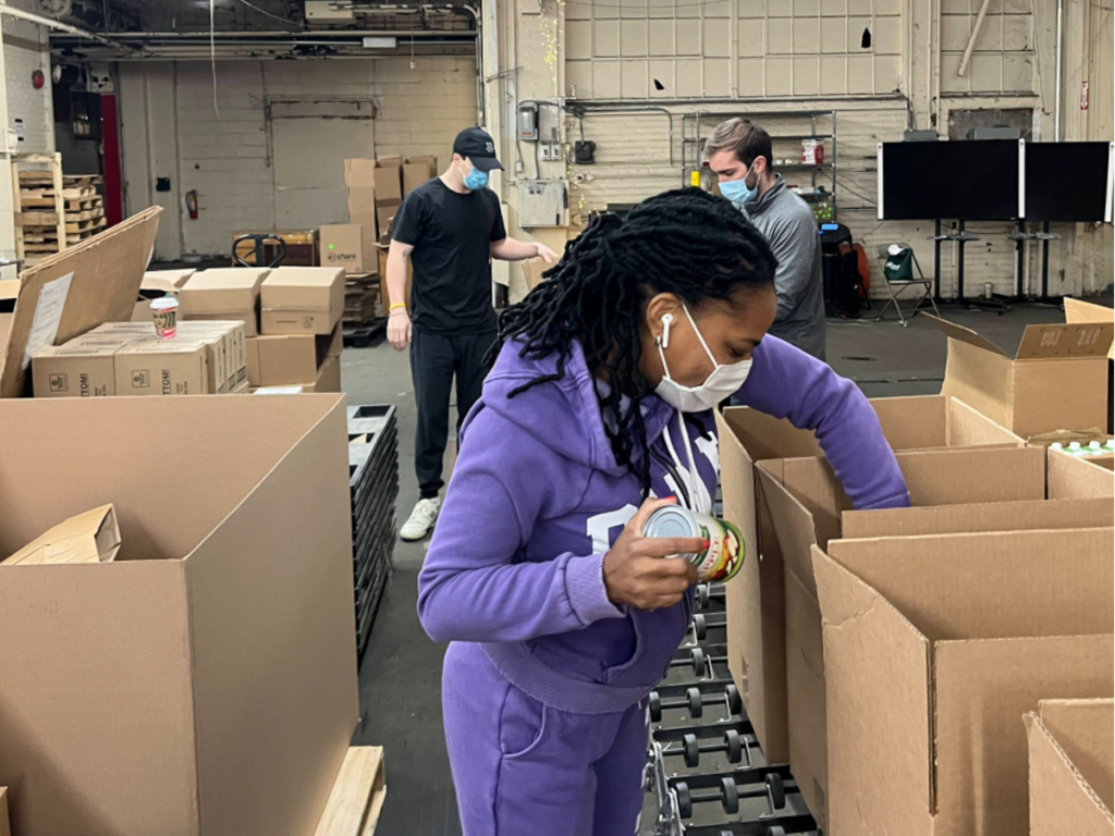 Photo of several people volunteering at a food bank