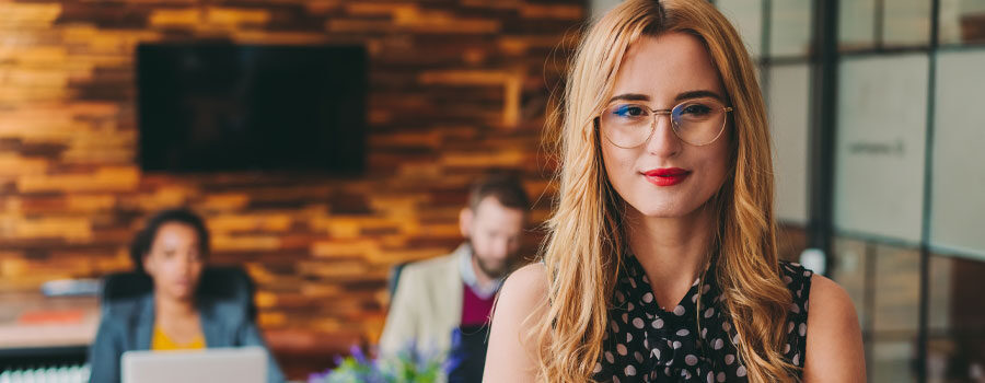 young professional woman standing in office